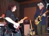 Jimmy drums in back while Tony and Webb shoot it out.